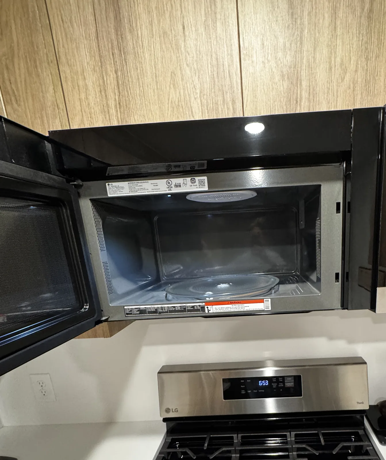 Microwave and gas cooktop cleaned inside and out during an Airbnb turnover in Salt Lake City, Utah